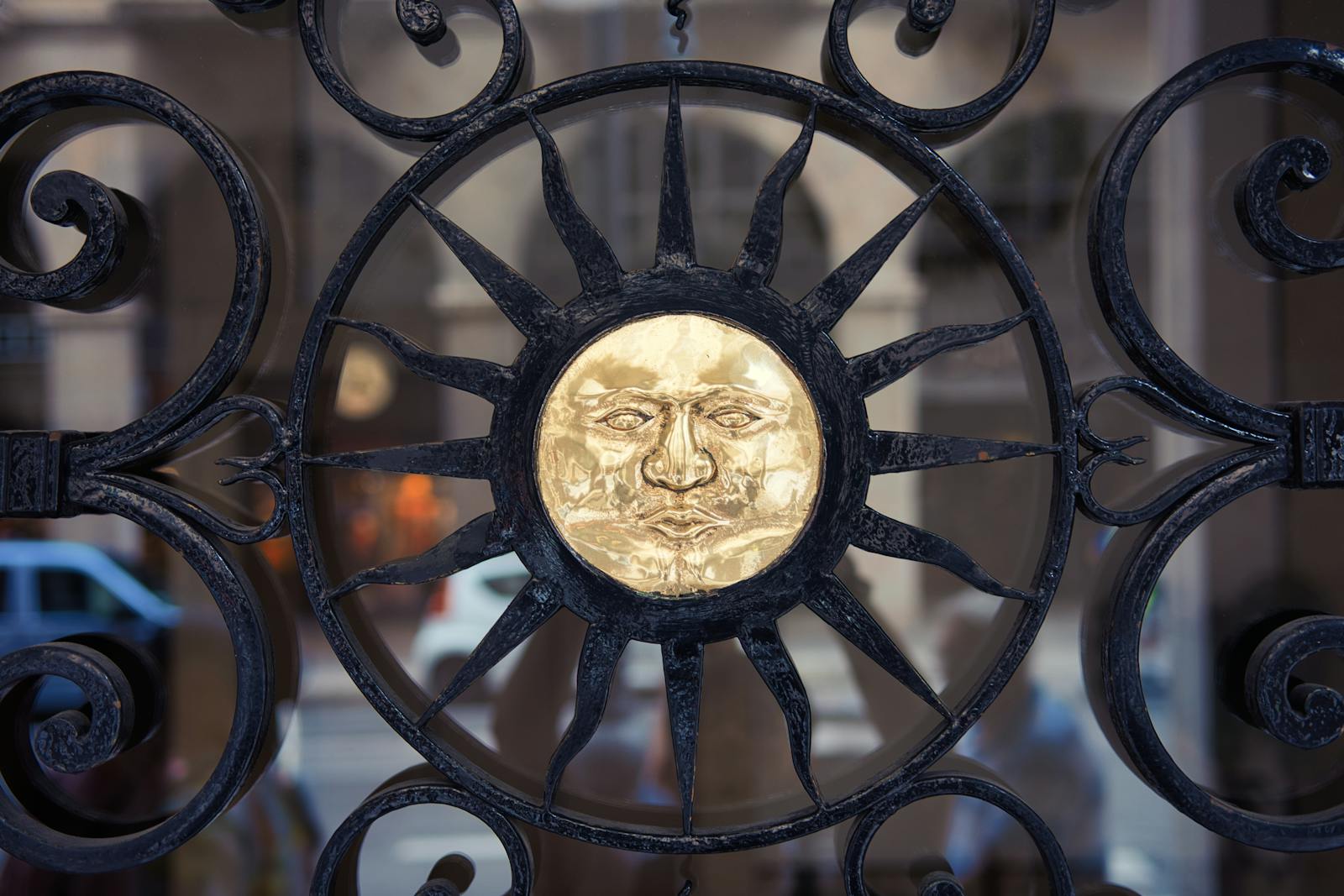 Close-up Photo of a Carved Sun on a Fence